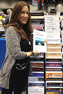 Alex with some of her music at the Hal Leonard rack at the Midwest Clinic, 2014.
